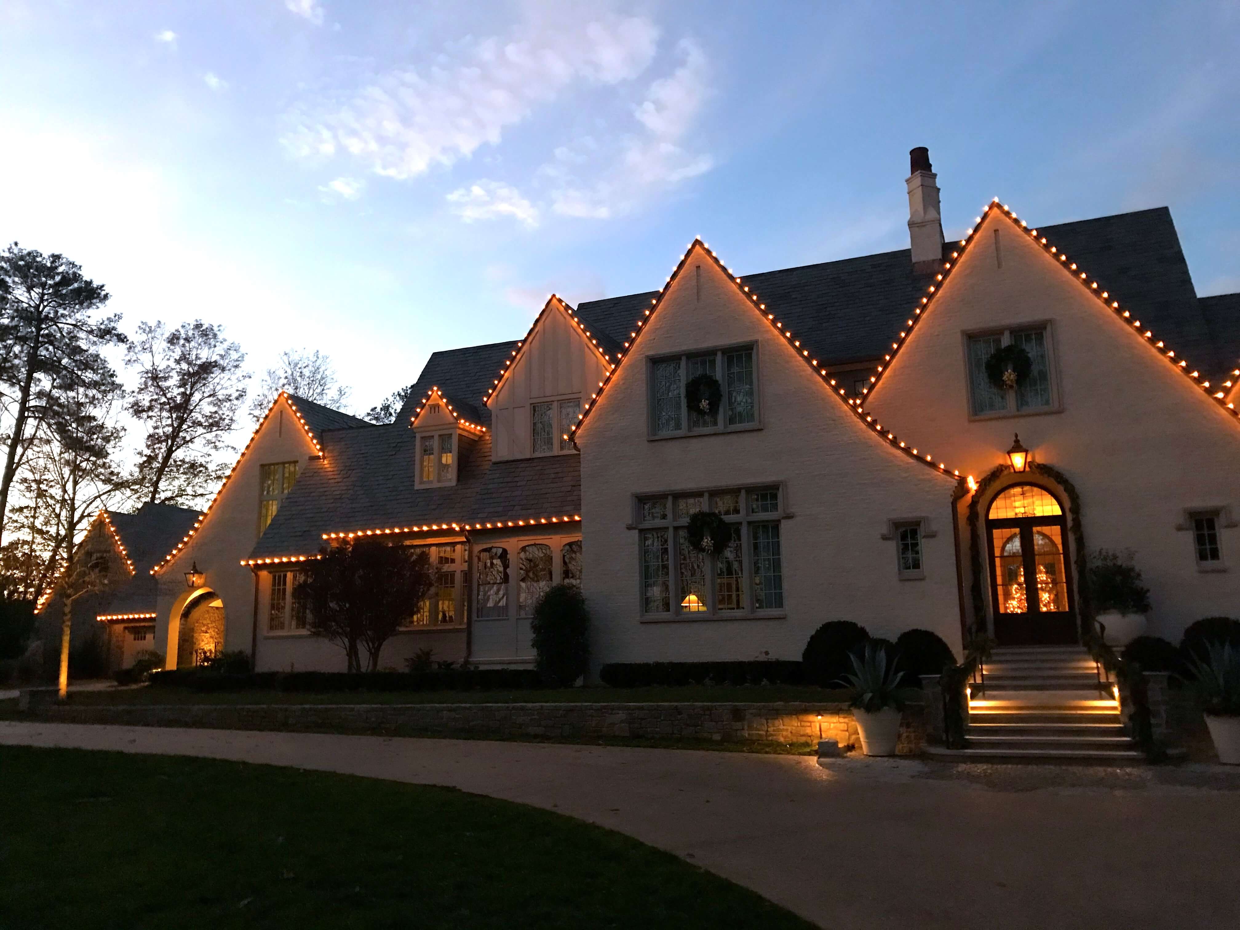 Professional warm white Christmas roofline lighting in Buckhead GA