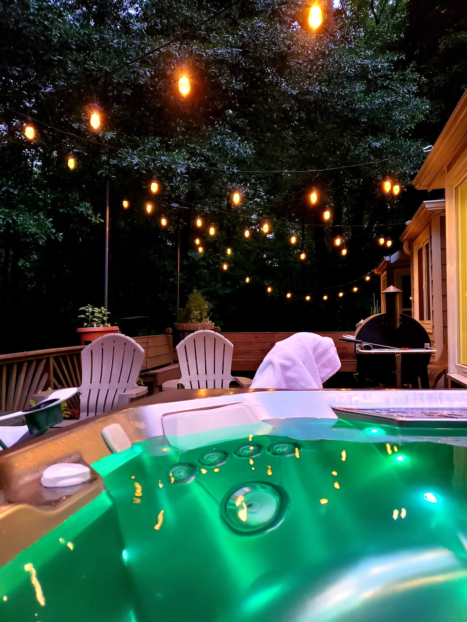 Overhead bistro string lights installed on a residential deck in Sandy Springs